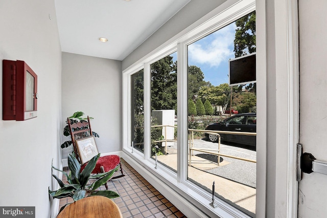 doorway to outside with a healthy amount of sunlight and tile patterned flooring