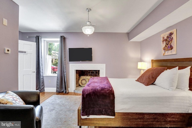 bedroom featuring a notable chandelier and light wood-type flooring