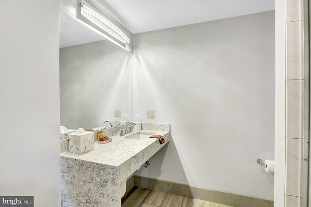 bathroom with hardwood / wood-style flooring and sink