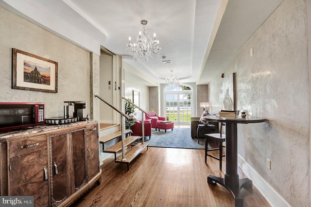 interior space with a chandelier and hardwood / wood-style floors