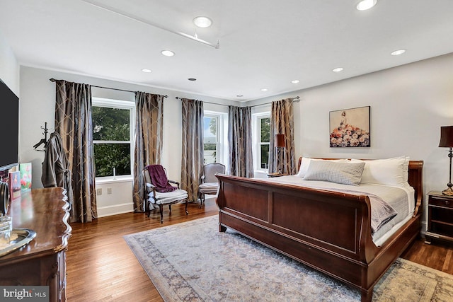 bedroom with dark wood-type flooring