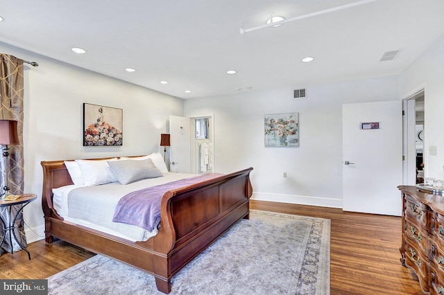 bedroom with dark wood-type flooring