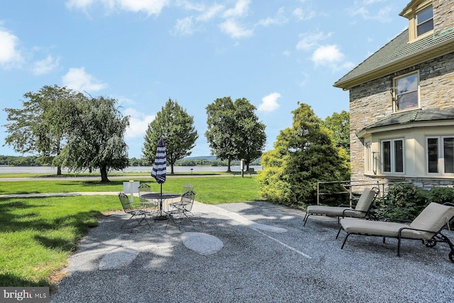 view of community with a yard and a patio area