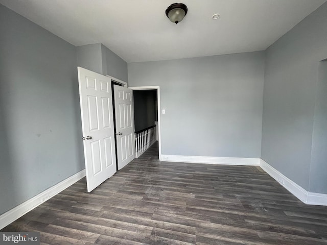 unfurnished bedroom featuring dark hardwood / wood-style flooring