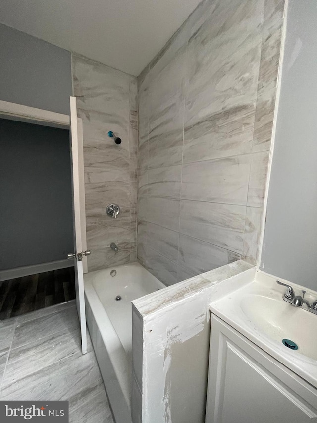 bathroom with vanity and tiled shower / bath combo