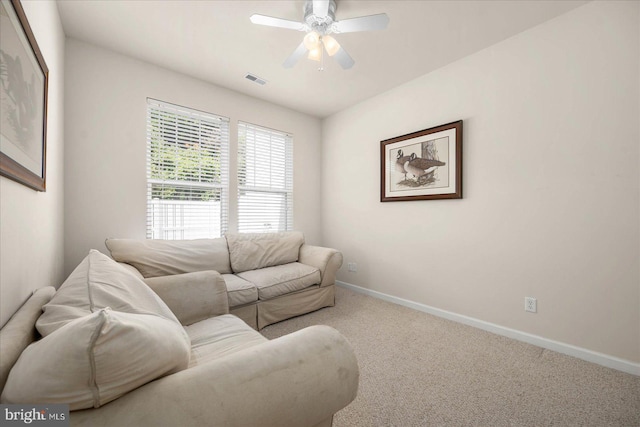 living room featuring ceiling fan and light colored carpet