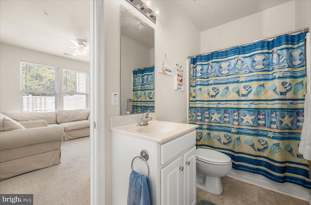 bathroom featuring toilet, tile patterned flooring, vanity, ceiling fan, and a shower with curtain