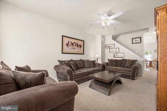 living room featuring ceiling fan and carpet