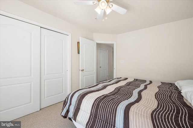 carpeted bedroom with a closet and ceiling fan