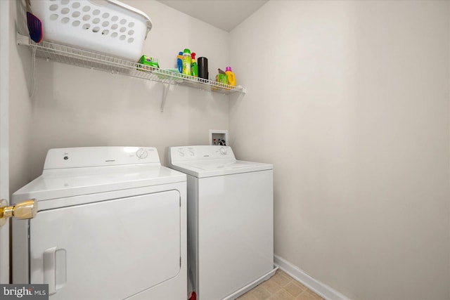 laundry room with light tile patterned floors and washer and dryer