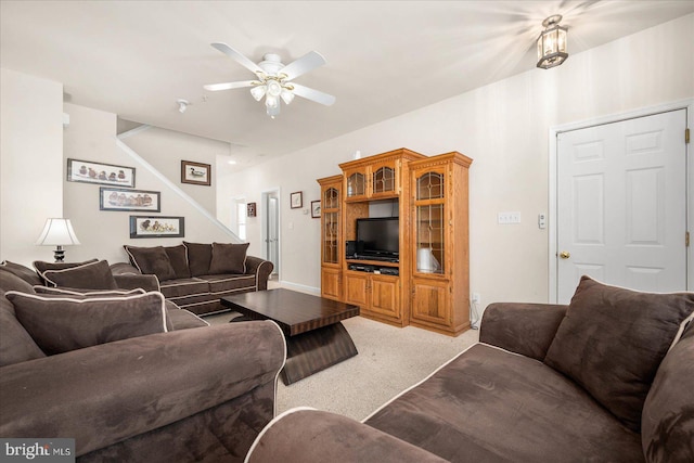 carpeted living room featuring ceiling fan