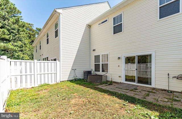 rear view of property with a lawn