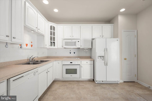 kitchen with white appliances, light tile patterned floors, backsplash, and sink