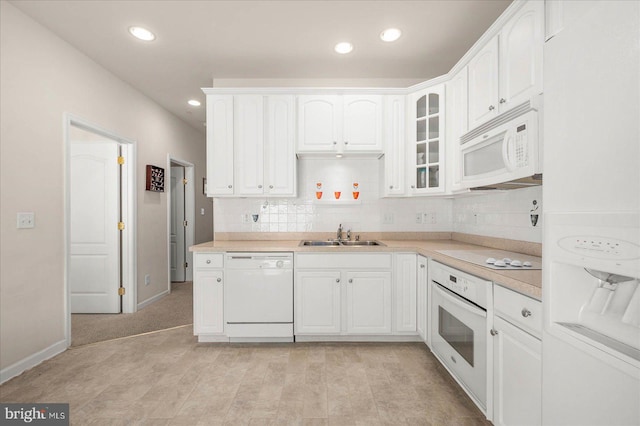 kitchen with sink, light tile patterned floors, white appliances, and decorative backsplash