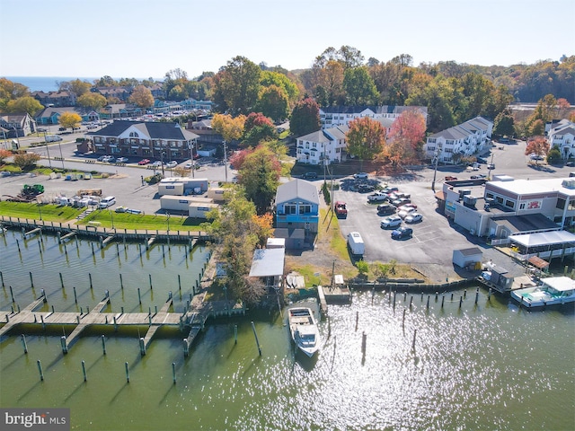 drone / aerial view with a water view and a residential view