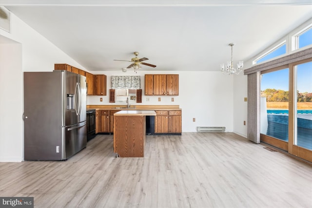 kitchen featuring a kitchen island, light countertops, hanging light fixtures, baseboard heating, and stainless steel refrigerator with ice dispenser