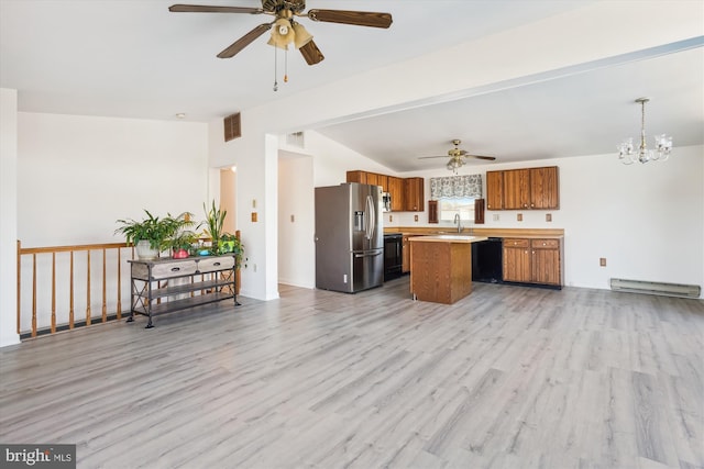 kitchen with a baseboard radiator, open floor plan, light countertops, brown cabinetry, and stainless steel fridge