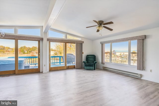 unfurnished room featuring a wealth of natural light, a baseboard radiator, light wood-type flooring, and vaulted ceiling with beams