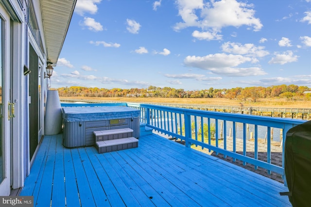 wooden terrace featuring a hot tub