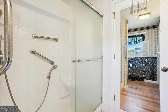 full bath featuring a stall shower and wood finished floors