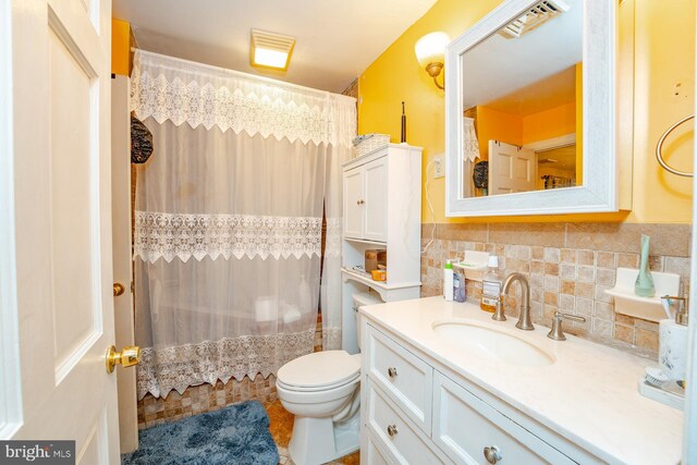 full bathroom with backsplash, toilet, tile patterned flooring, vanity, and tile walls