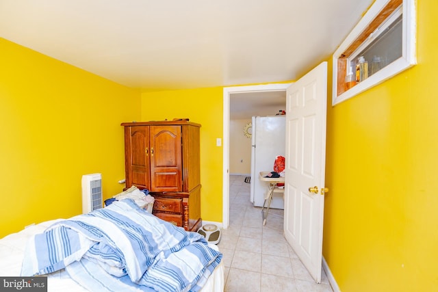 tiled bedroom with white fridge