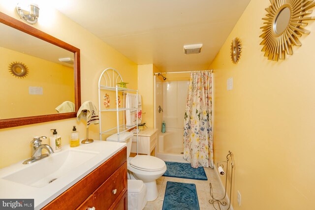 bathroom with toilet, vanity, walk in shower, and tile patterned floors