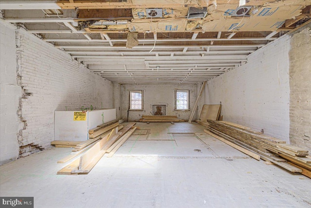 basement featuring brick wall