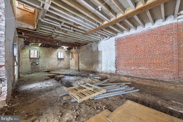 basement with brick wall