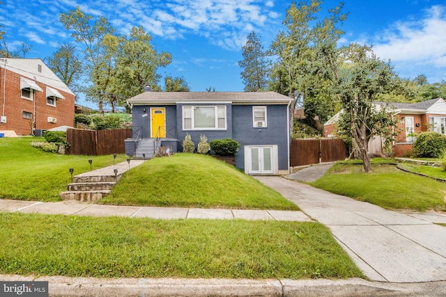 bungalow-style home with brick siding, a chimney, a front yard, and fence