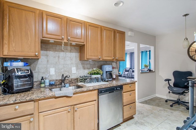 kitchen with pendant lighting, dishwasher, light stone countertops, and sink