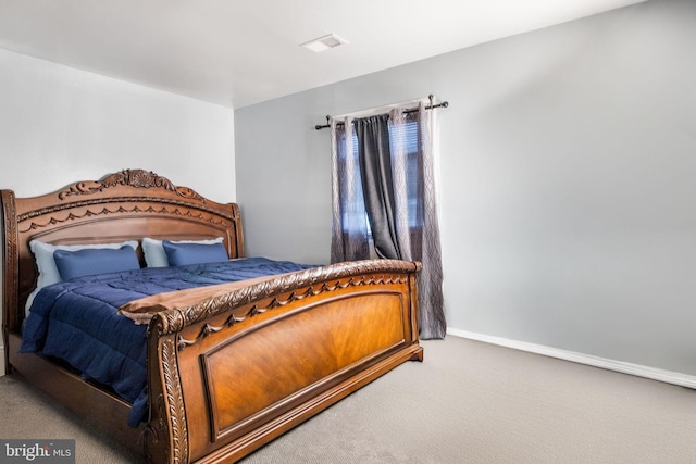 carpeted bedroom with visible vents and baseboards