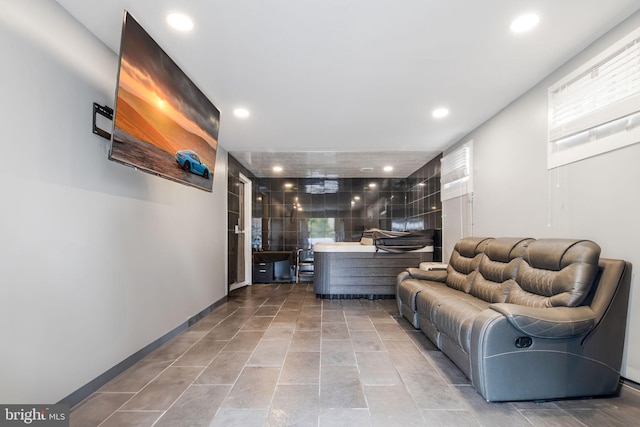 living area with a healthy amount of sunlight, baseboards, and recessed lighting