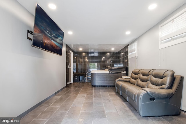 living room with recessed lighting, plenty of natural light, and baseboards