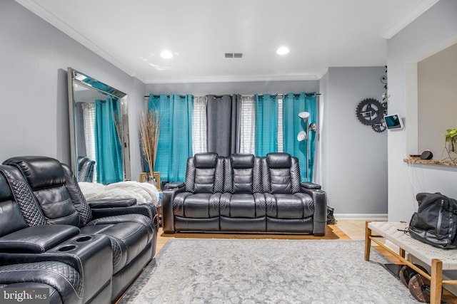 cinema room featuring crown molding and hardwood / wood-style floors