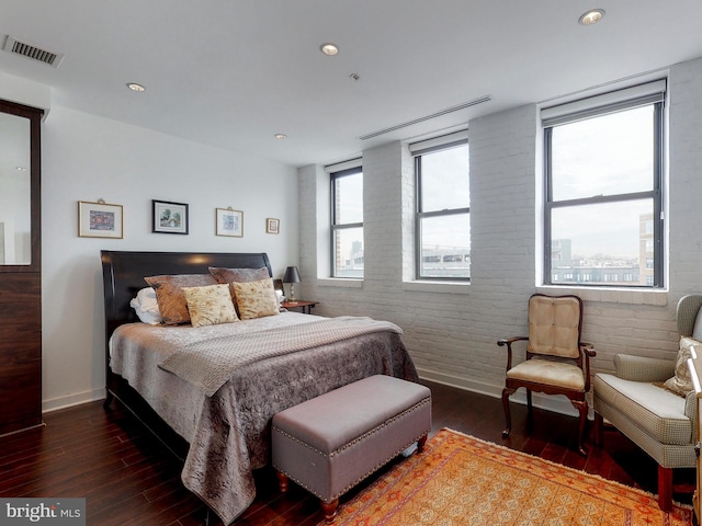 bedroom with baseboards, visible vents, dark wood finished floors, and recessed lighting