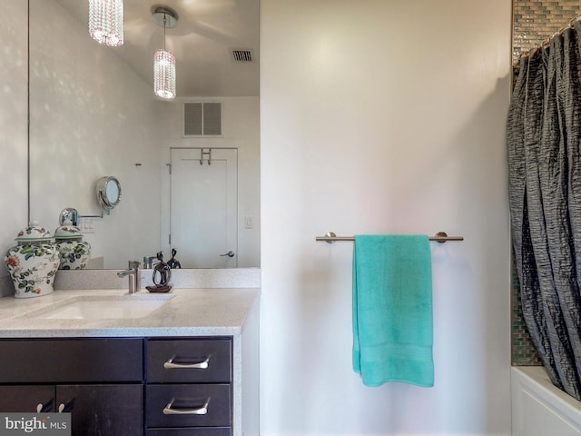 bathroom featuring shower / tub combo with curtain and vanity