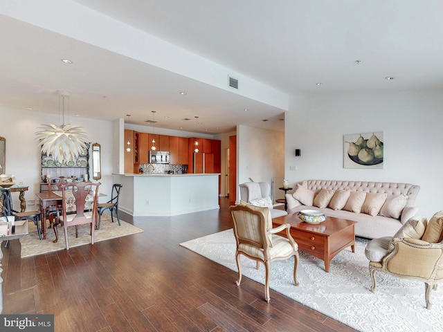 living area featuring visible vents, dark wood-style flooring, and recessed lighting