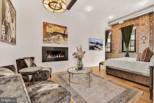 interior space featuring brick wall and light wood-type flooring