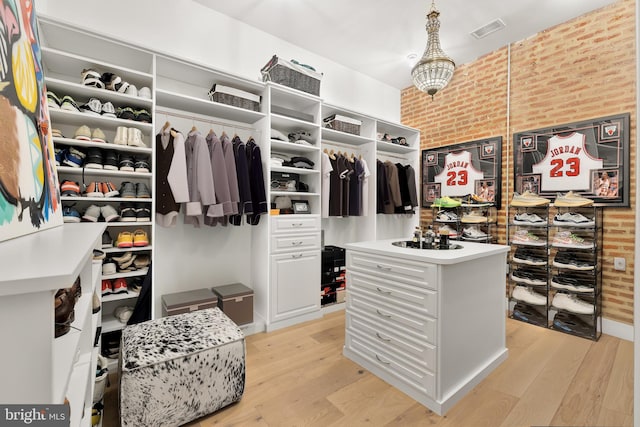 spacious closet with light wood-type flooring and visible vents