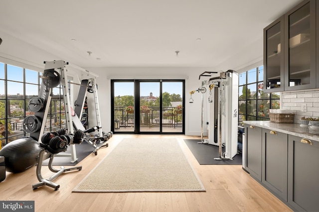 exercise room with light wood-style floors