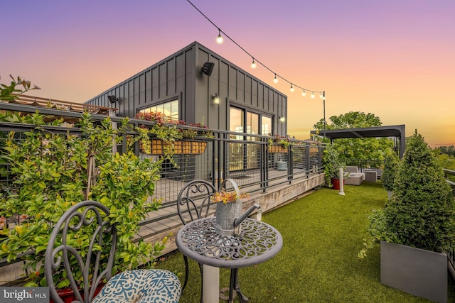 view of side of home featuring a lawn and board and batten siding