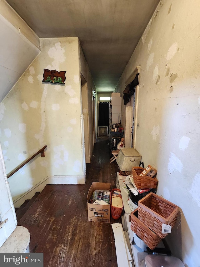 corridor with dark hardwood / wood-style flooring