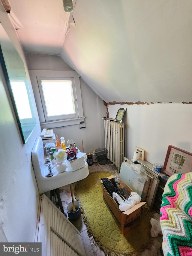 bonus room featuring radiator heating unit and vaulted ceiling