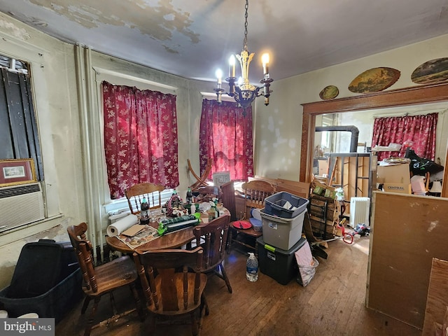 dining room featuring a notable chandelier, hardwood / wood-style floors, and radiator