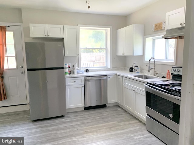 kitchen featuring light wood-type flooring, plenty of natural light, and stainless steel appliances