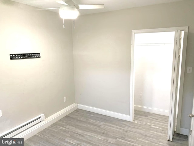 interior space featuring baseboard heating, a closet, light wood-type flooring, and ceiling fan