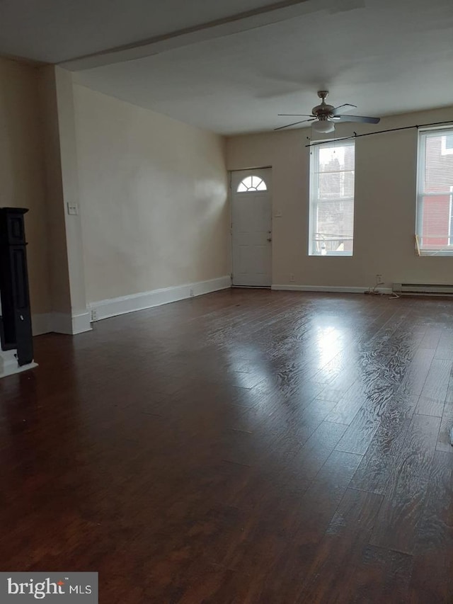 interior space with hardwood / wood-style floors, ceiling fan, and baseboard heating