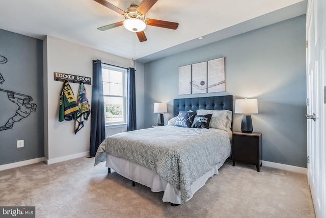 bedroom with a ceiling fan, baseboards, and light carpet