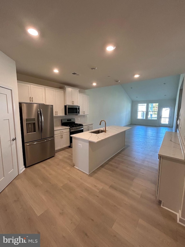 kitchen featuring visible vents, appliances with stainless steel finishes, light wood-style floors, and a sink